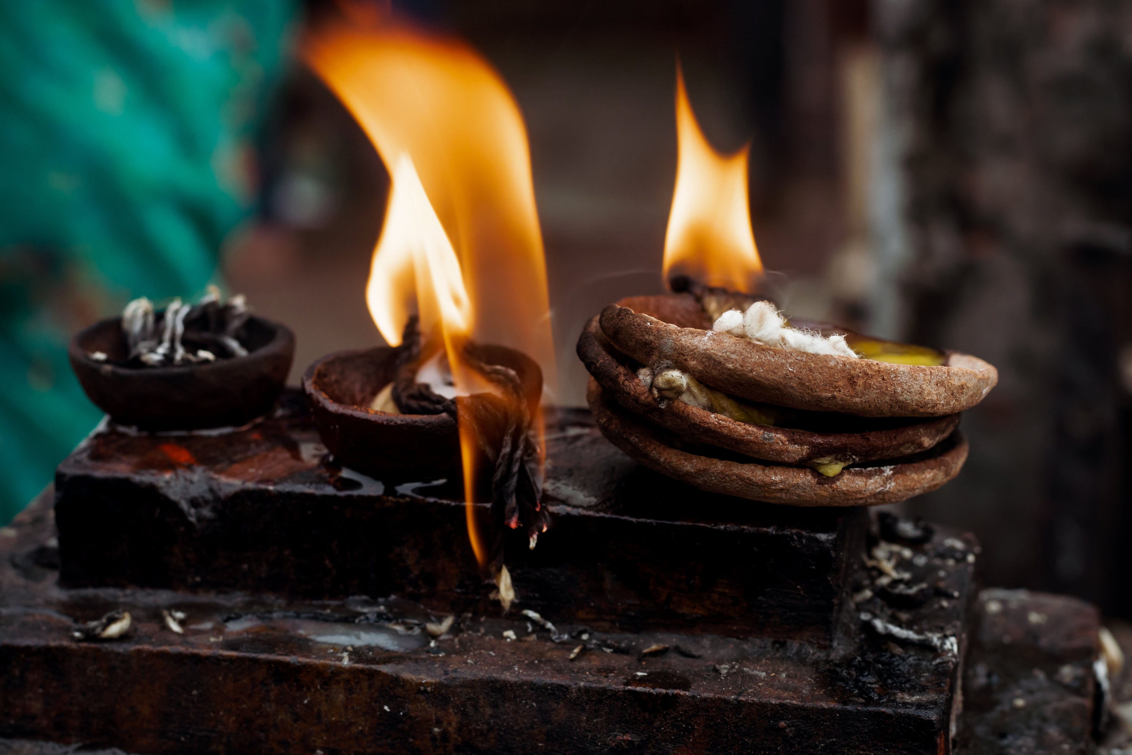 Three small pots with flames on a dark background